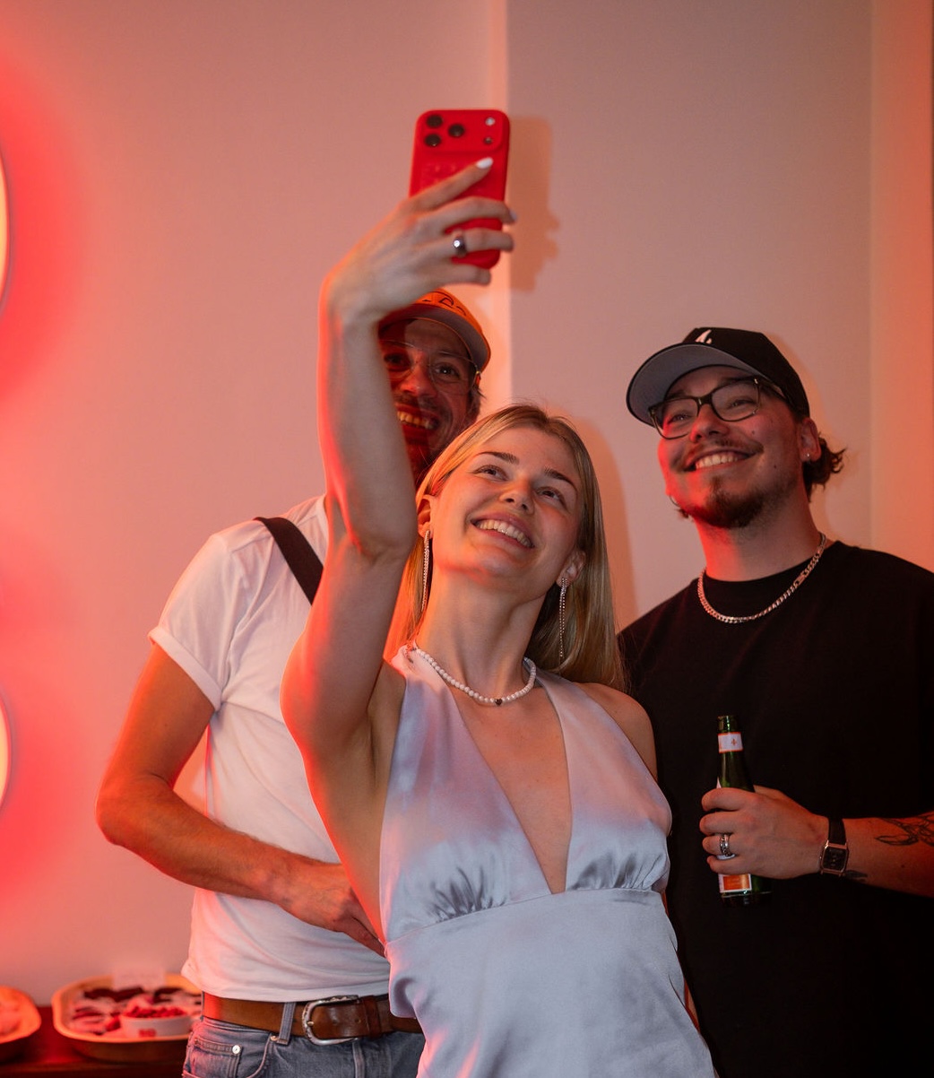 Sechs Mitglieder der Community lachen bei einem Sommer-Event zusammen